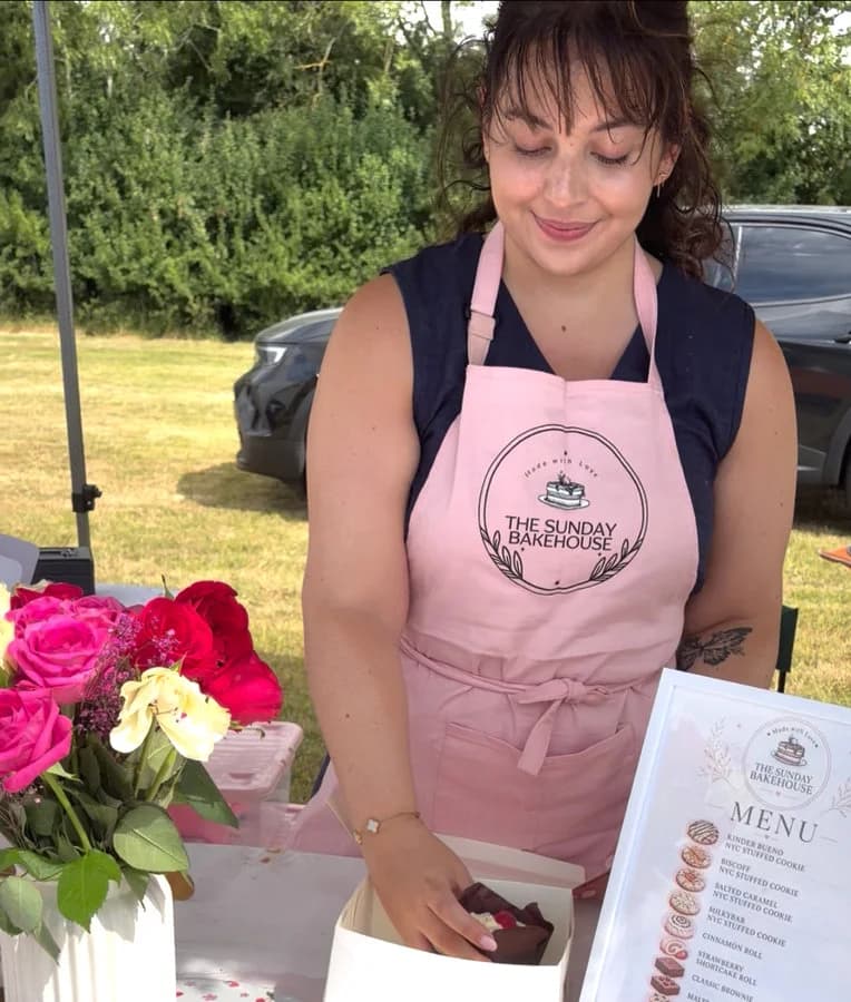 Emilia serving customers at a market