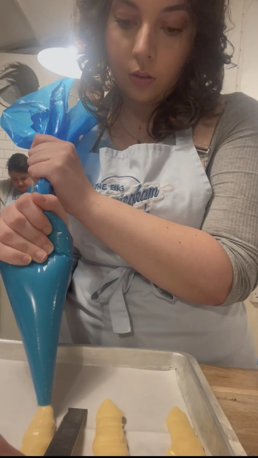 Emilia decorating bakes with buttercream