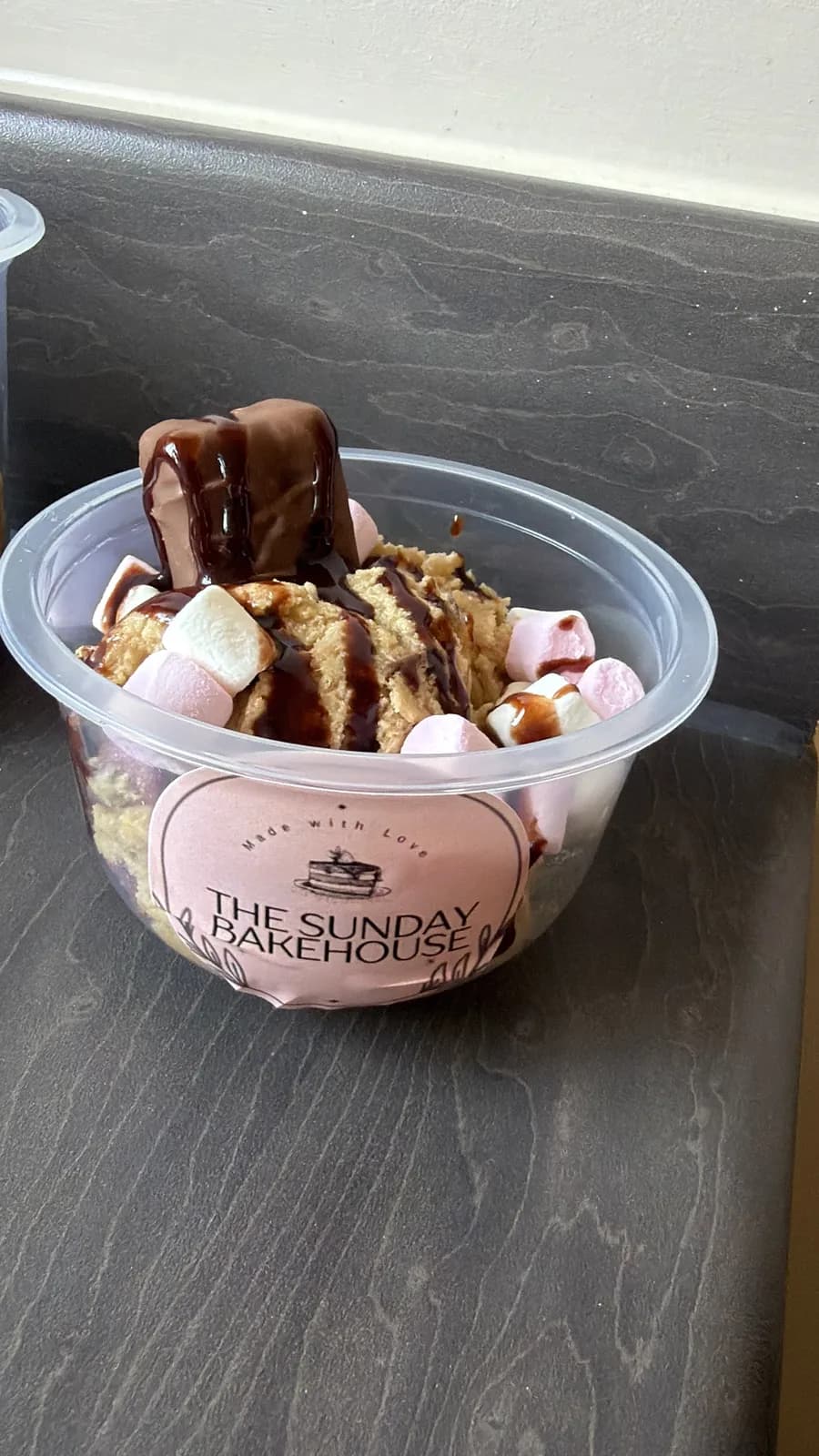 A Sunday Bakehouse cookie dough cup with marshmallows and chocolate drizzle